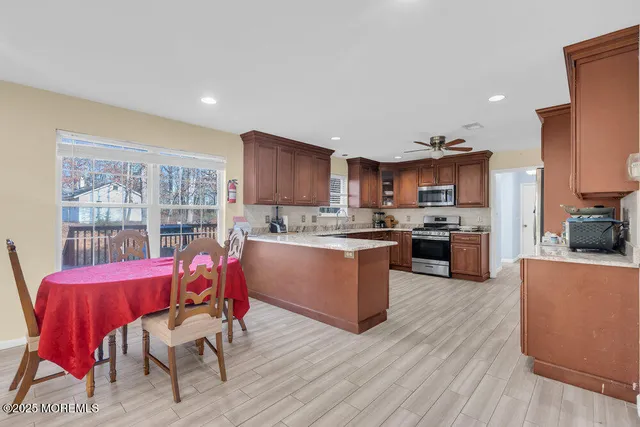 a living room with stainless steel appliances kitchen island granite countertop furniture and a kitchen view