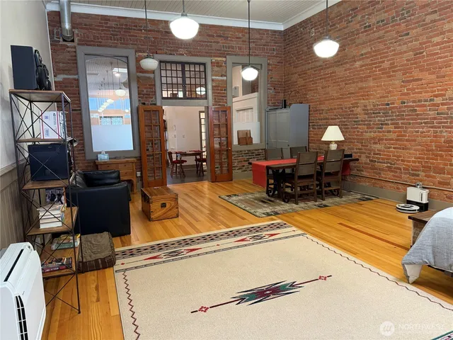 a view of living room and kitchen with furniture wooden floor and window