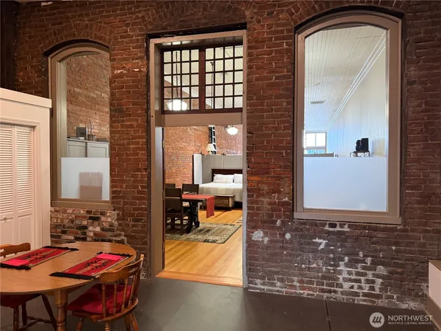 a kitchen with stainless steel appliances granite countertop a refrigerator a sink a stove a microwave and wooden cabinets