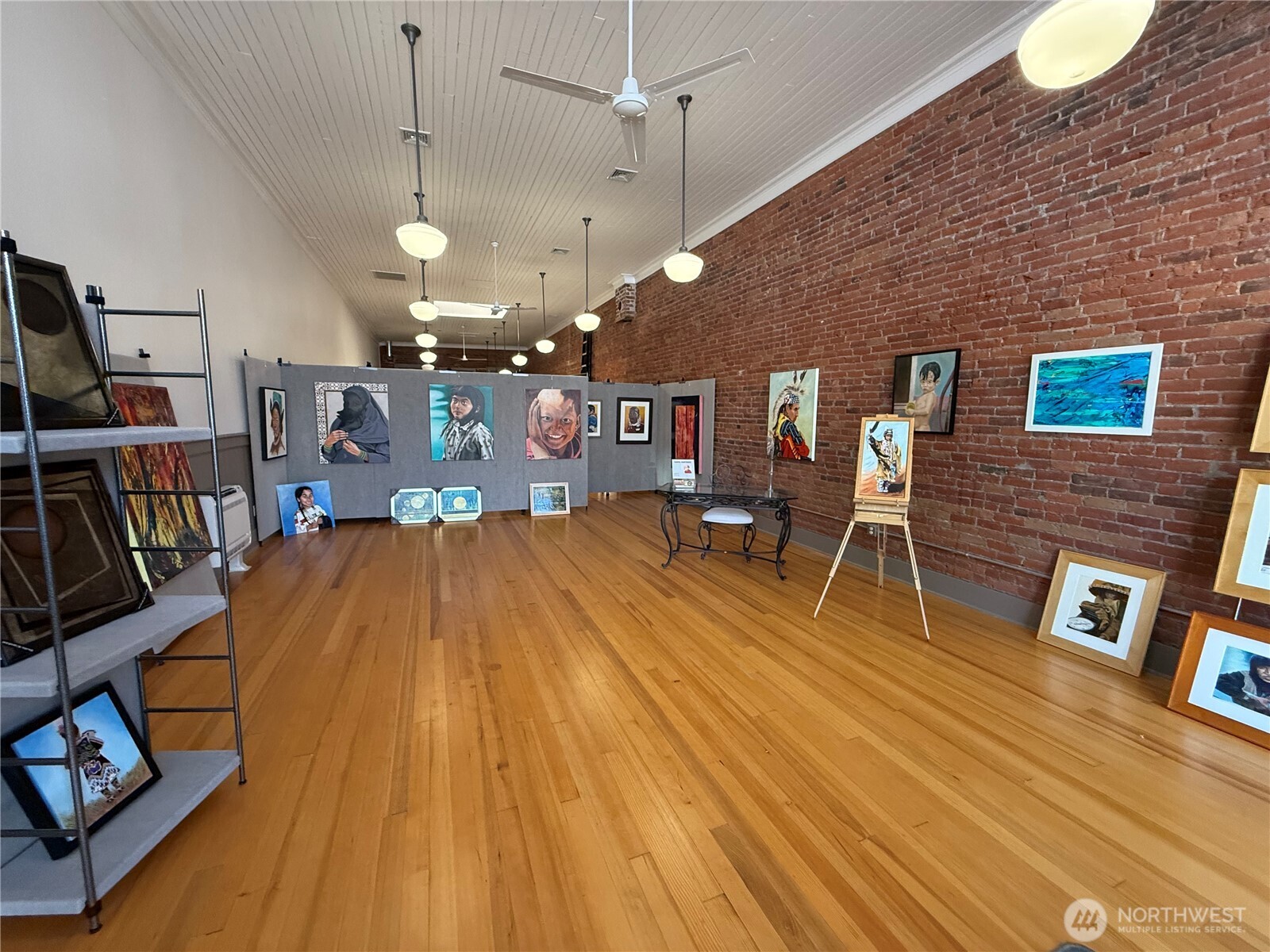 250 East Main Street Dayton, WA 99328 - Photo 6 of 33 a living room with stainless steel appliances wooden floor and a bookshelf
