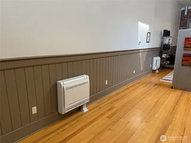 a view of a kitchen with wooden floor and cabinets