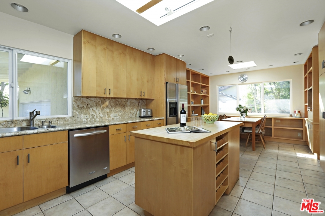 1629 Tower Grove Drive Beverly Hills, CA 90210 - Photo 11 of 29 a kitchen with a sink and cabinets