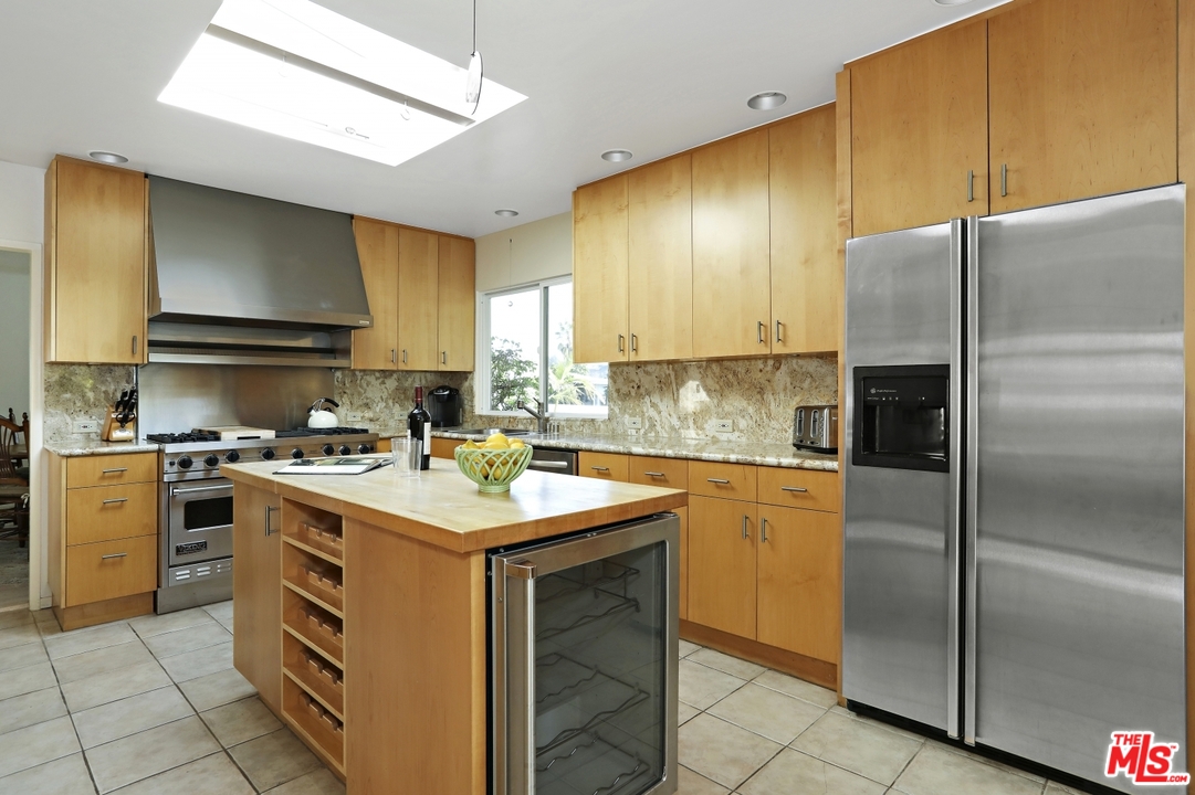1629 Tower Grove Drive Beverly Hills, CA 90210 - Photo 12 of 29 a kitchen with a sink appliances and cabinets