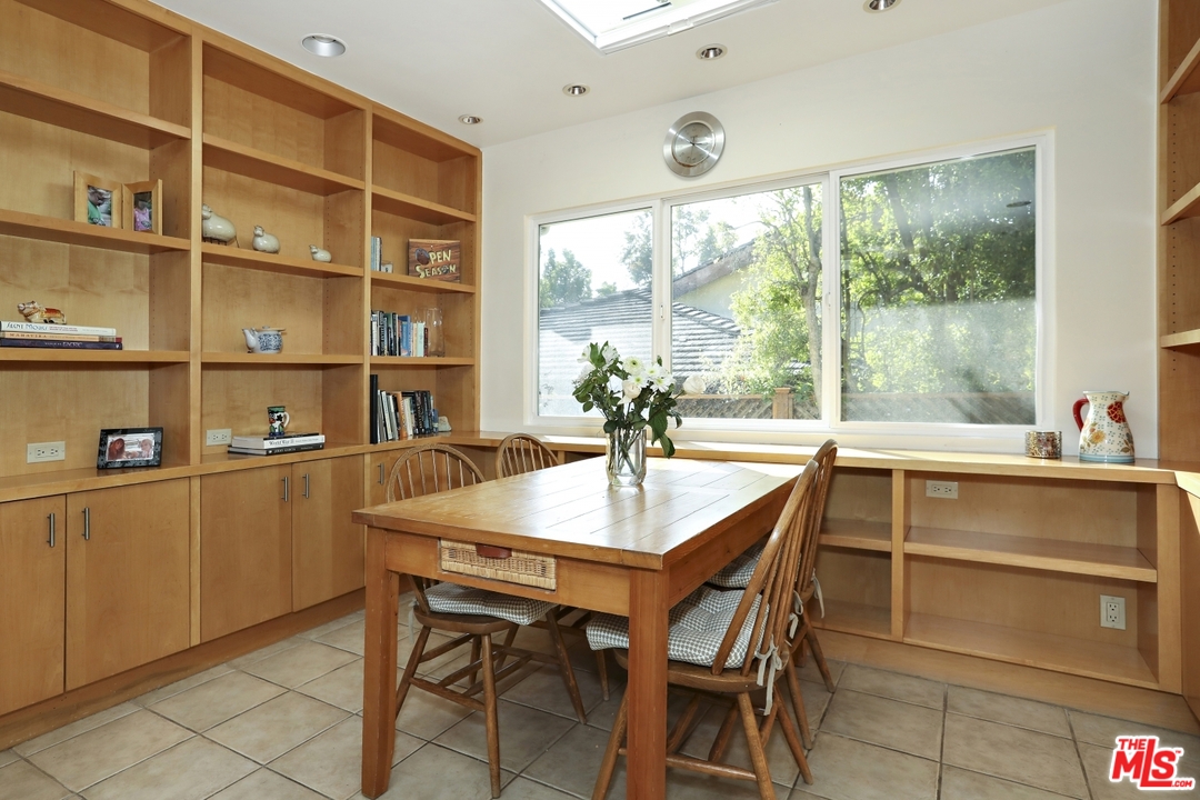 1629 Tower Grove Drive Beverly Hills, CA 90210 - Photo 14 of 29 a dining room with a table and chairs