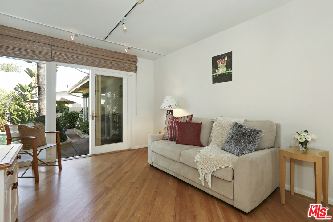 1629 Tower Grove Drive Beverly Hills, CA 90210 - Photo 15 of 29 a living room with furniture and wooden floor
