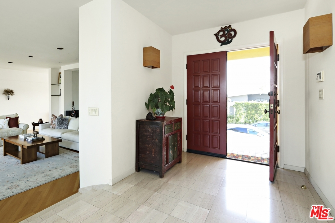 1629 Tower Grove Drive Beverly Hills, CA 90210 - Photo 3 of 29 a view of living room filled with furniture and a potted plant