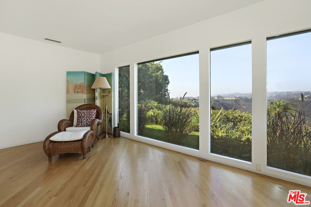1629 Tower Grove Drive Beverly Hills, CA 90210 - Photo 21 of 29 a living room with furniture and a large window