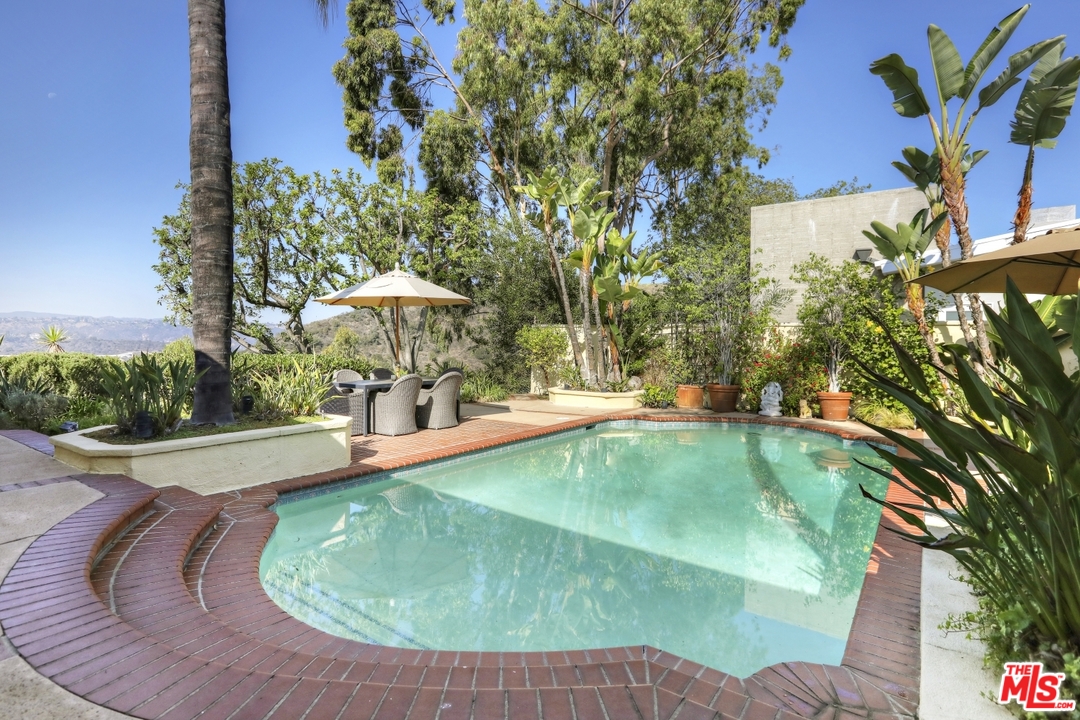 1629 Tower Grove Drive Beverly Hills, CA 90210 - Photo 25 of 29 a view of a swimming pool with a yard