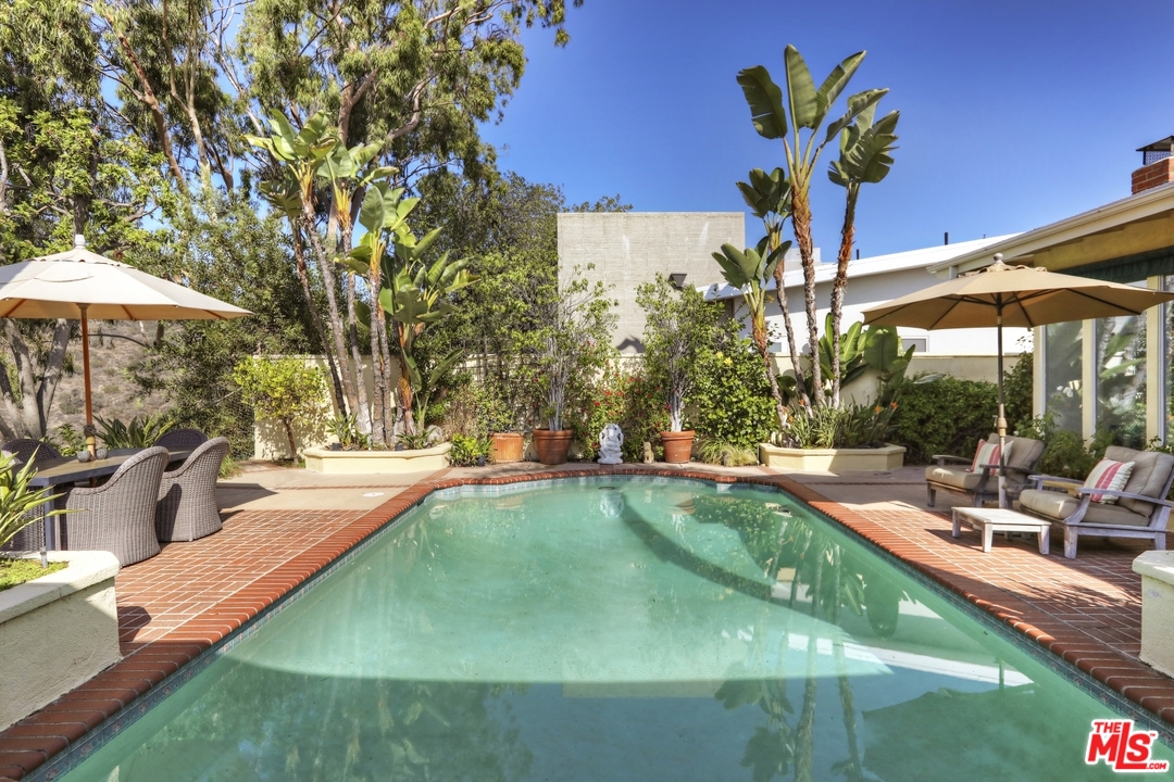 1629 Tower Grove Drive Beverly Hills, CA 90210 - Photo 26 of 29 a view of a swimming pool with a patio