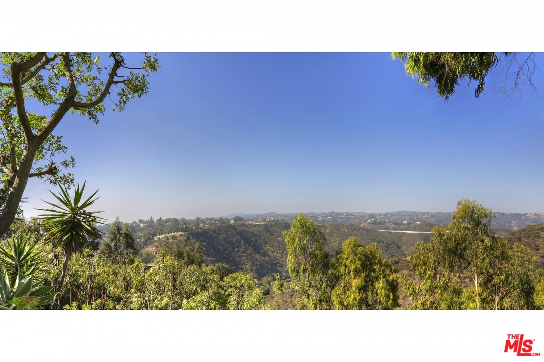 1629 Tower Grove Drive Beverly Hills, CA 90210 - Photo 29 of 29 a picture of a person on a street