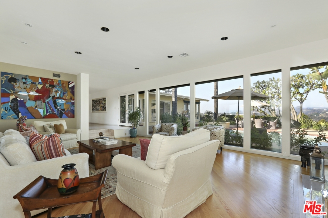 1629 Tower Grove Drive Beverly Hills, CA 90210 - Photo 7 of 29 a living room with furniture and a large window