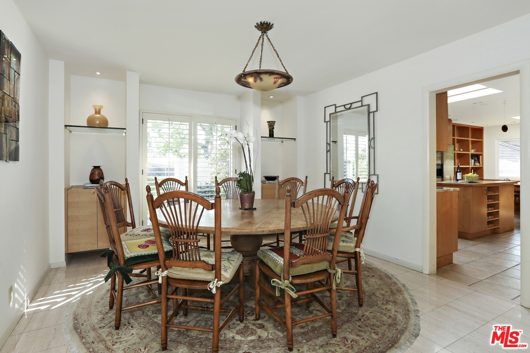 1629 Tower Grove Drive Beverly Hills, CA 90210 - Photo 10 of 29 a view of a dining room with furniture window and wooden floor