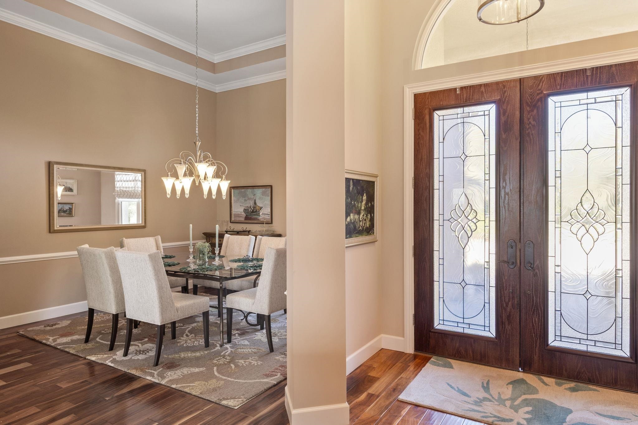 409 Lookout Point Drive St. Augustine, FL 32080 - Photo 11 of 90 Entryway with hanging lights, dark wood-type flooring, ornamental molding, french doors, and a high ceiling