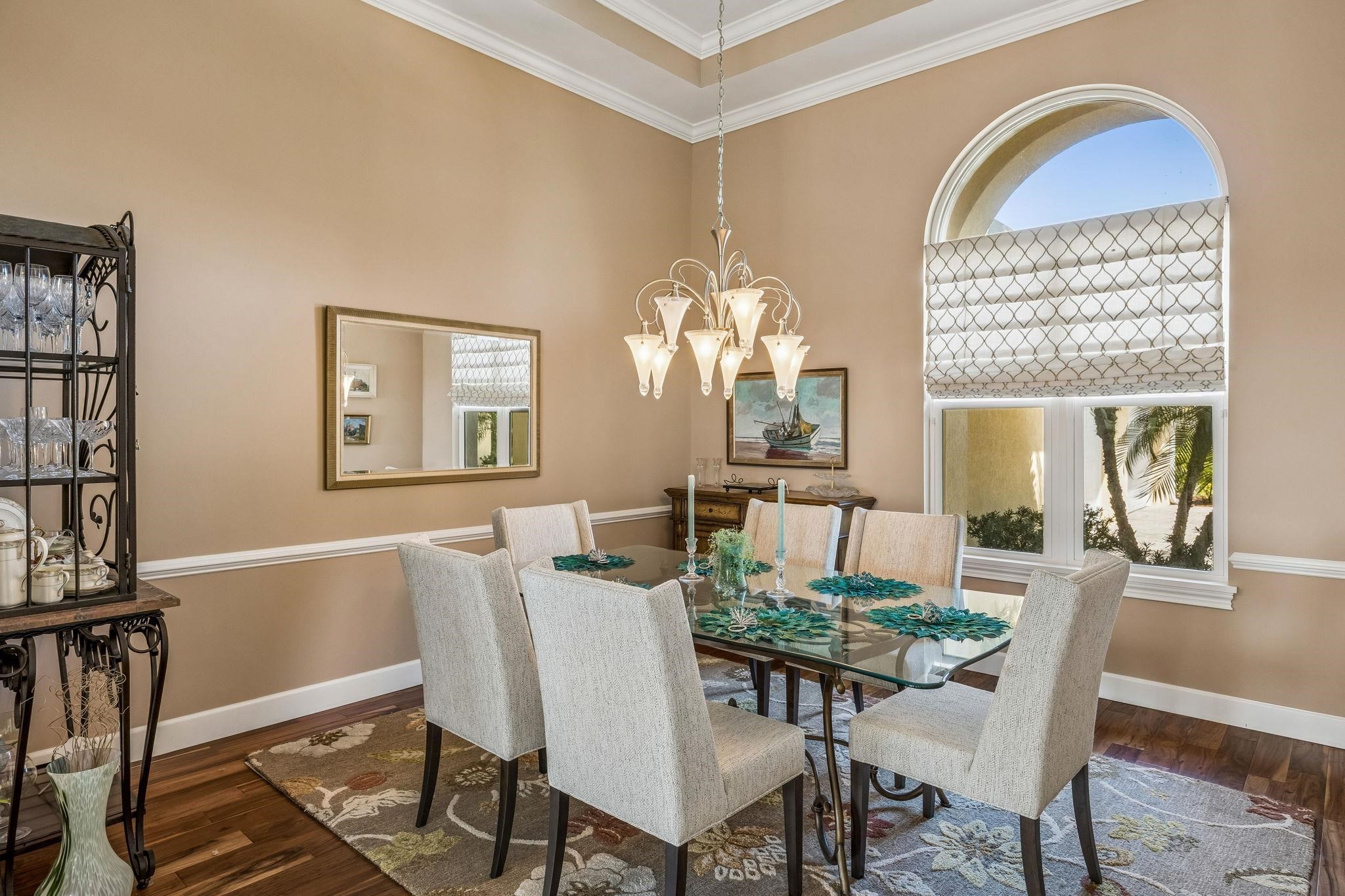 409 Lookout Point Drive St. Augustine, FL 32080 - Photo 12 of 90 Dining space featuring hanging lights, ornamental molding, wood finished floors, and a high ceiling
