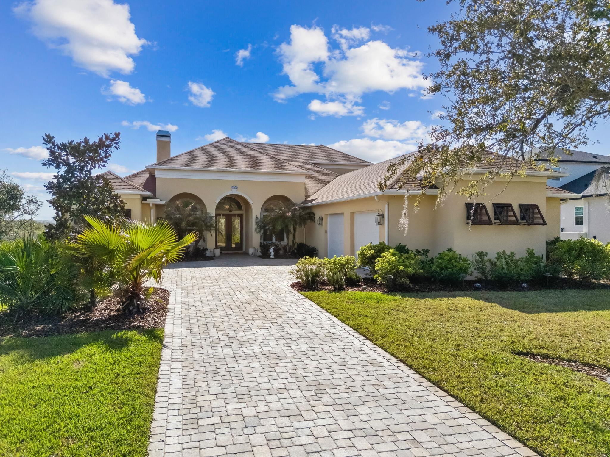 409 Lookout Point Drive St. Augustine, FL 32080 - Photo 2 of 90 Mediterranean / spanish house with stucco siding, a front yard, french doors, and a chimney