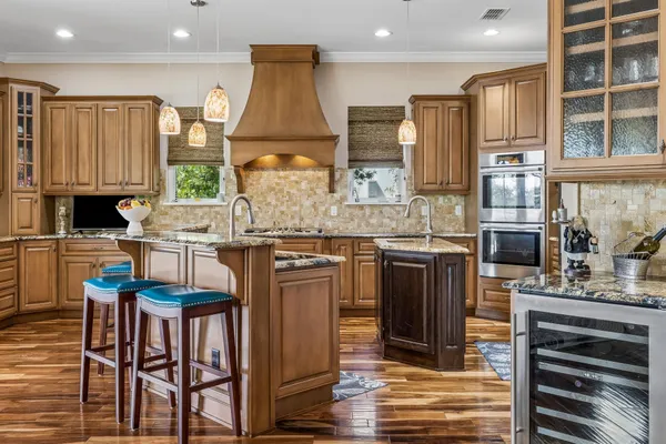 a bedroom with a bed mirror and clock on the wall