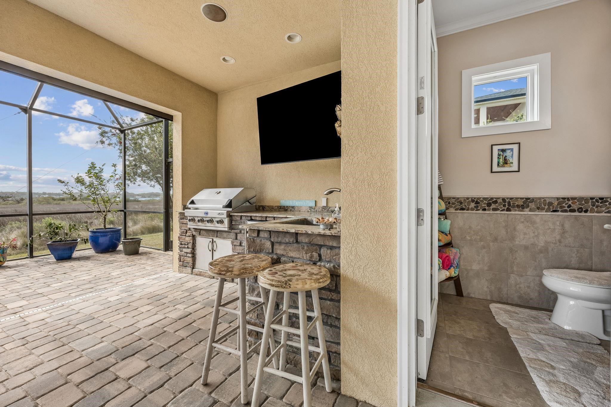 409 Lookout Point Drive St. Augustine, FL 32080 - Photo 29 of 90 View of patio with glass enclosure, an outdoor kitchen, and a sunroom