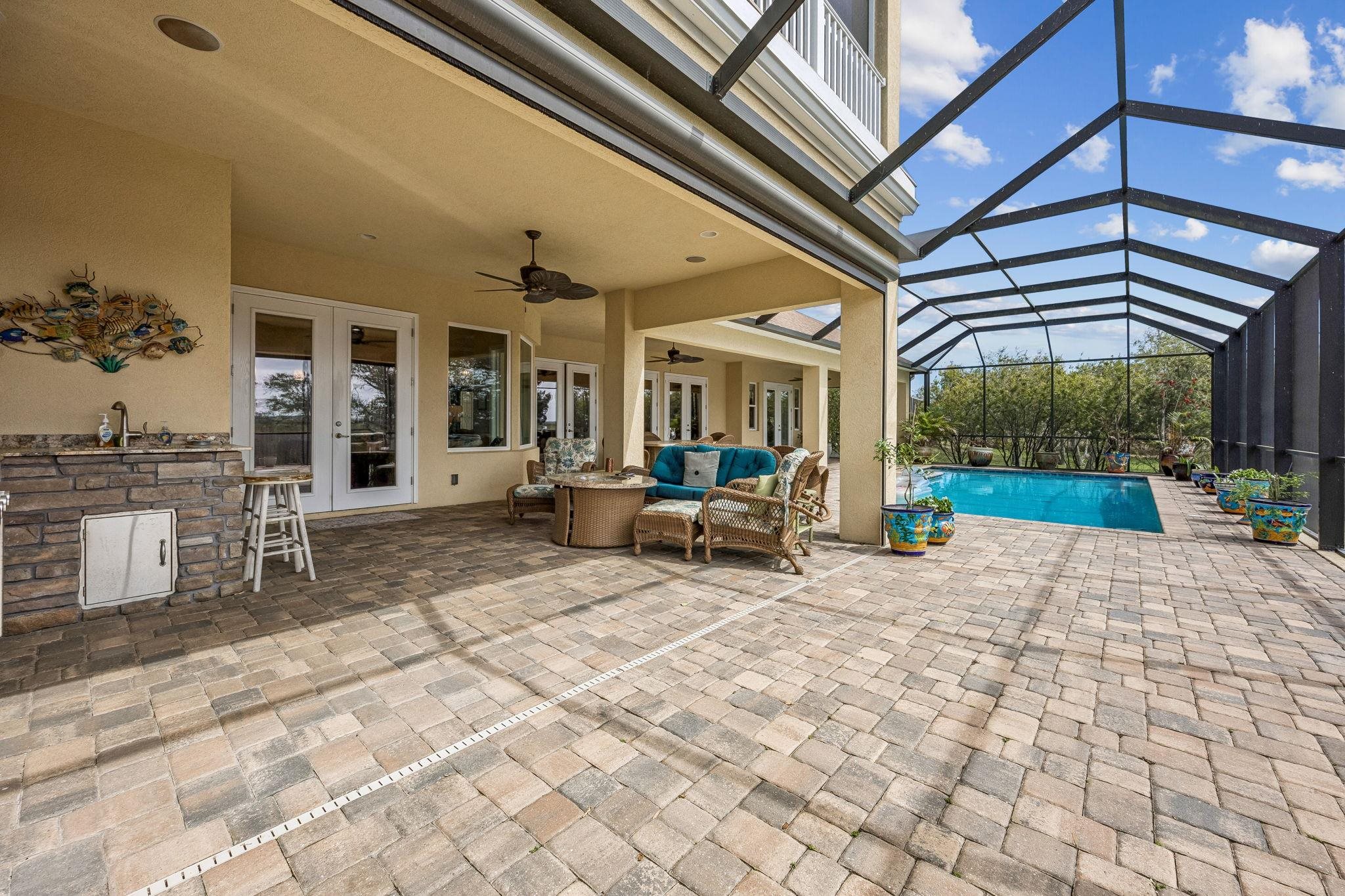 409 Lookout Point Drive St. Augustine, FL 32080 - Photo 35 of 90 View of patio featuring outdoor seating, french doors, a sunroom, ceiling fan, and an outdoor pool