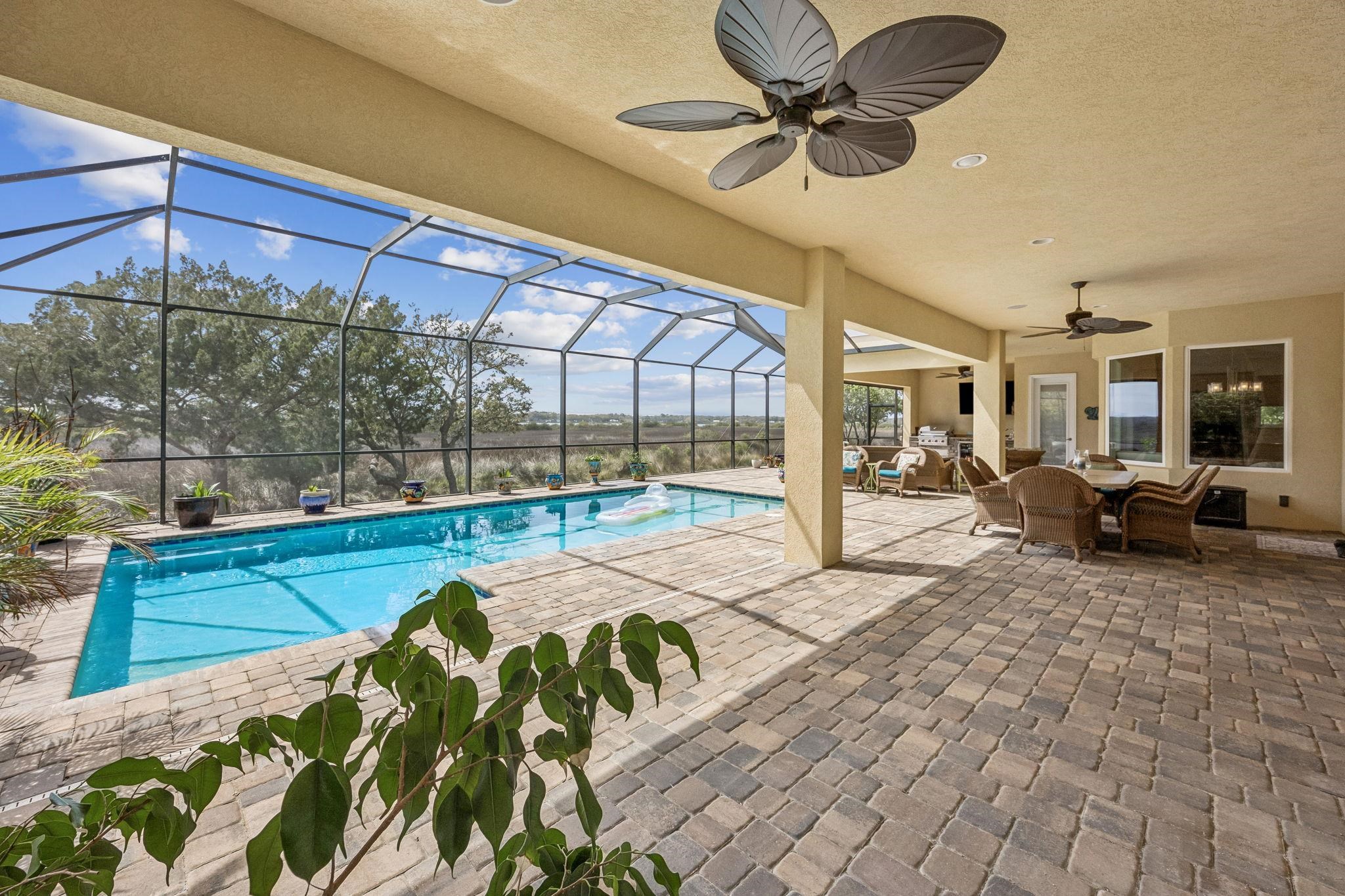 409 Lookout Point Drive St. Augustine, FL 32080 - Photo 36 of 90 Outdoor pool featuring a patio, a sunroom, outdoor dining space, and glass enclosure