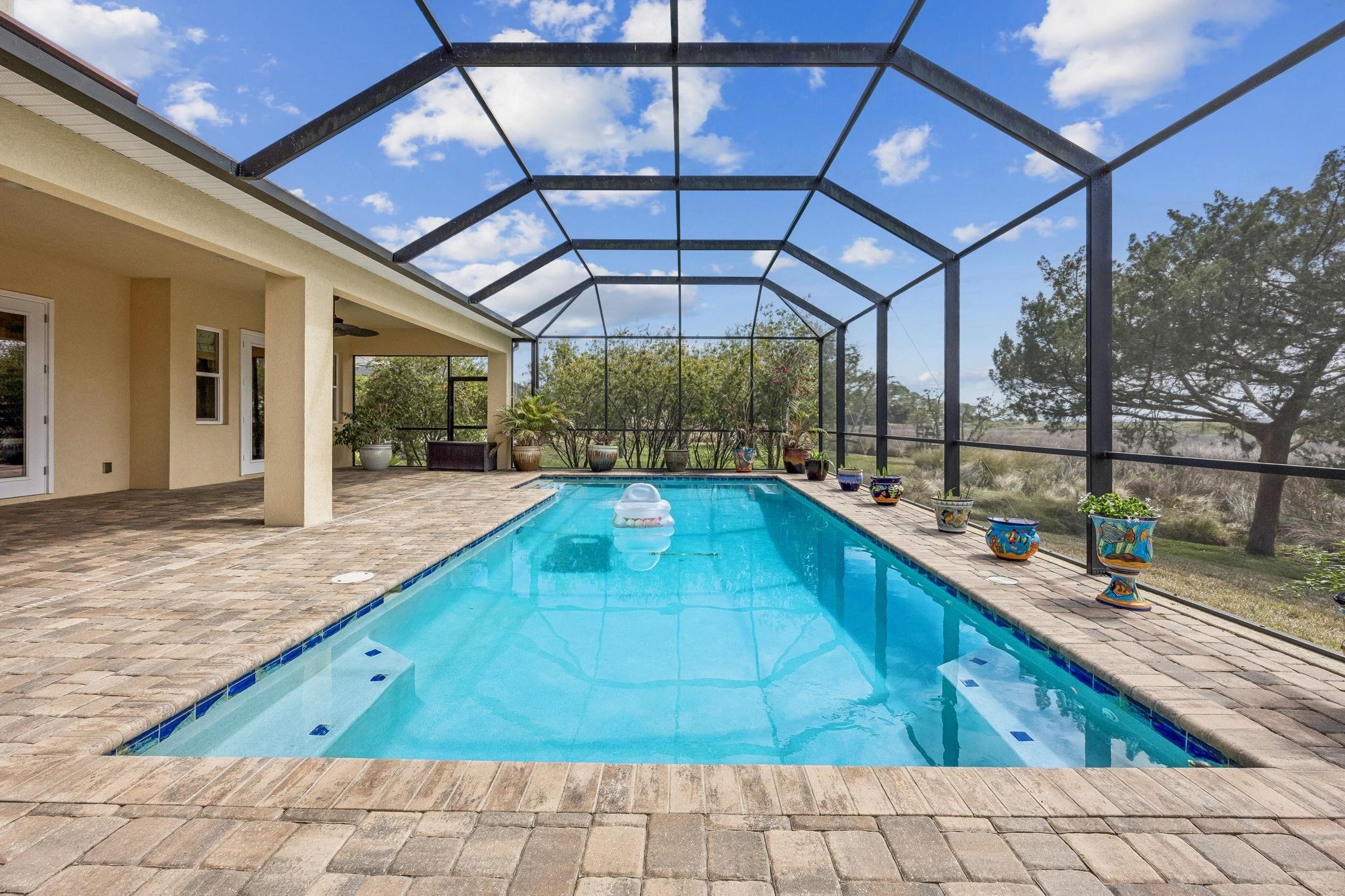 409 Lookout Point Drive St. Augustine, FL 32080 - Photo 37 of 90 Swimming pool with a sunroom, a patio area, and glass enclosure