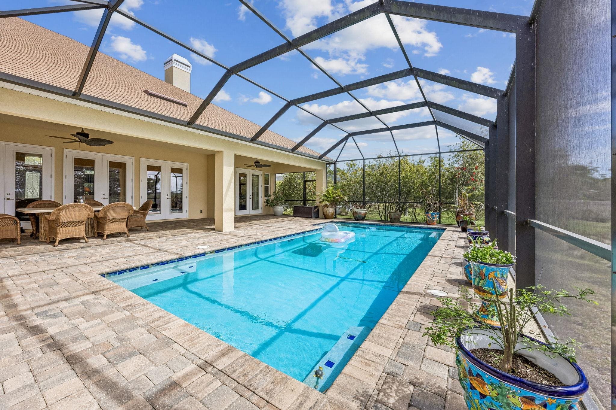 409 Lookout Point Drive St. Augustine, FL 32080 - Photo 39 of 90 a view of swimming pool with a lounge chairs in a patio