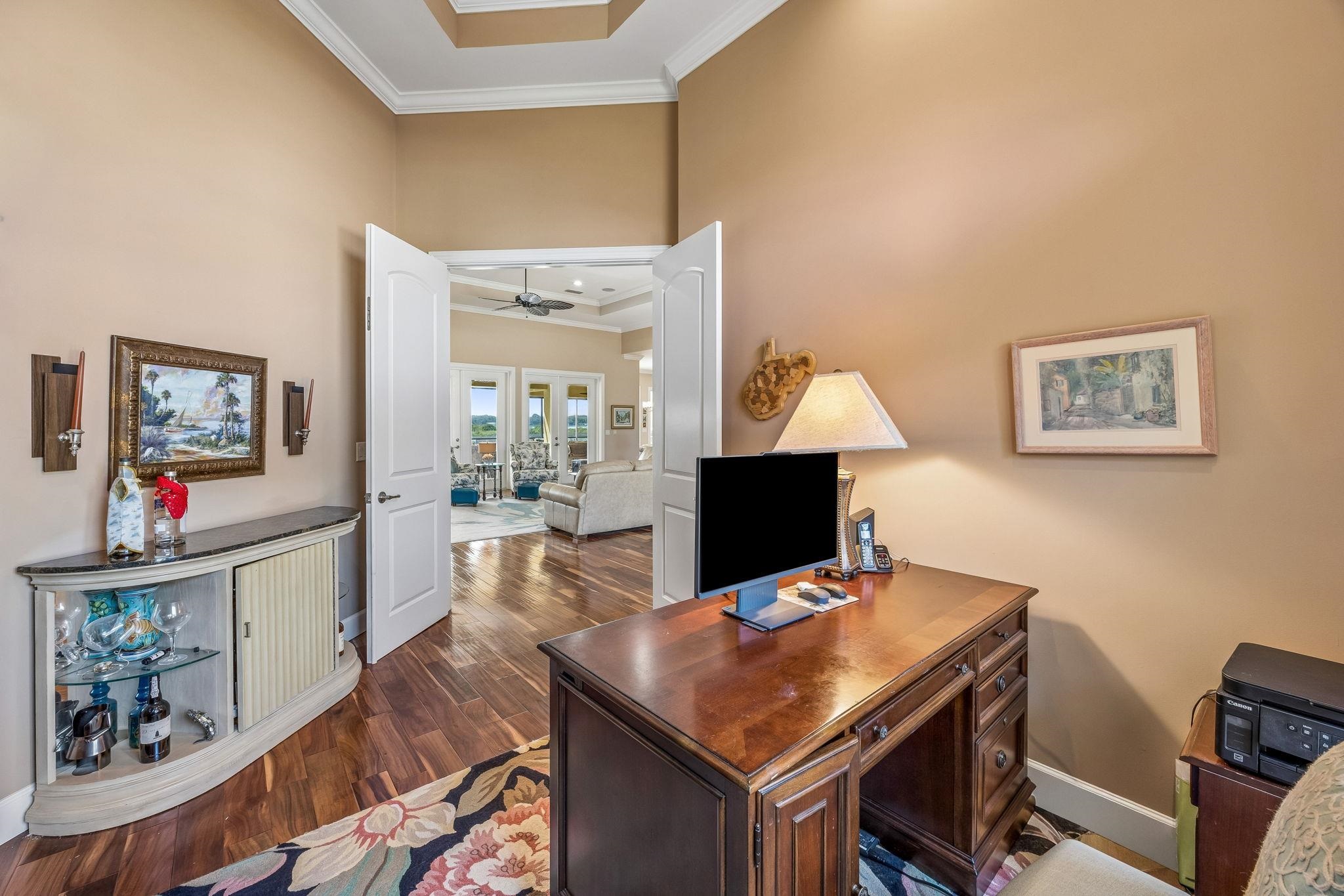 409 Lookout Point Drive St. Augustine, FL 32080 - Photo 44 of 90 Home office featuring dark wood-style floors, a high ceiling, ornamental molding, and ceiling fan
