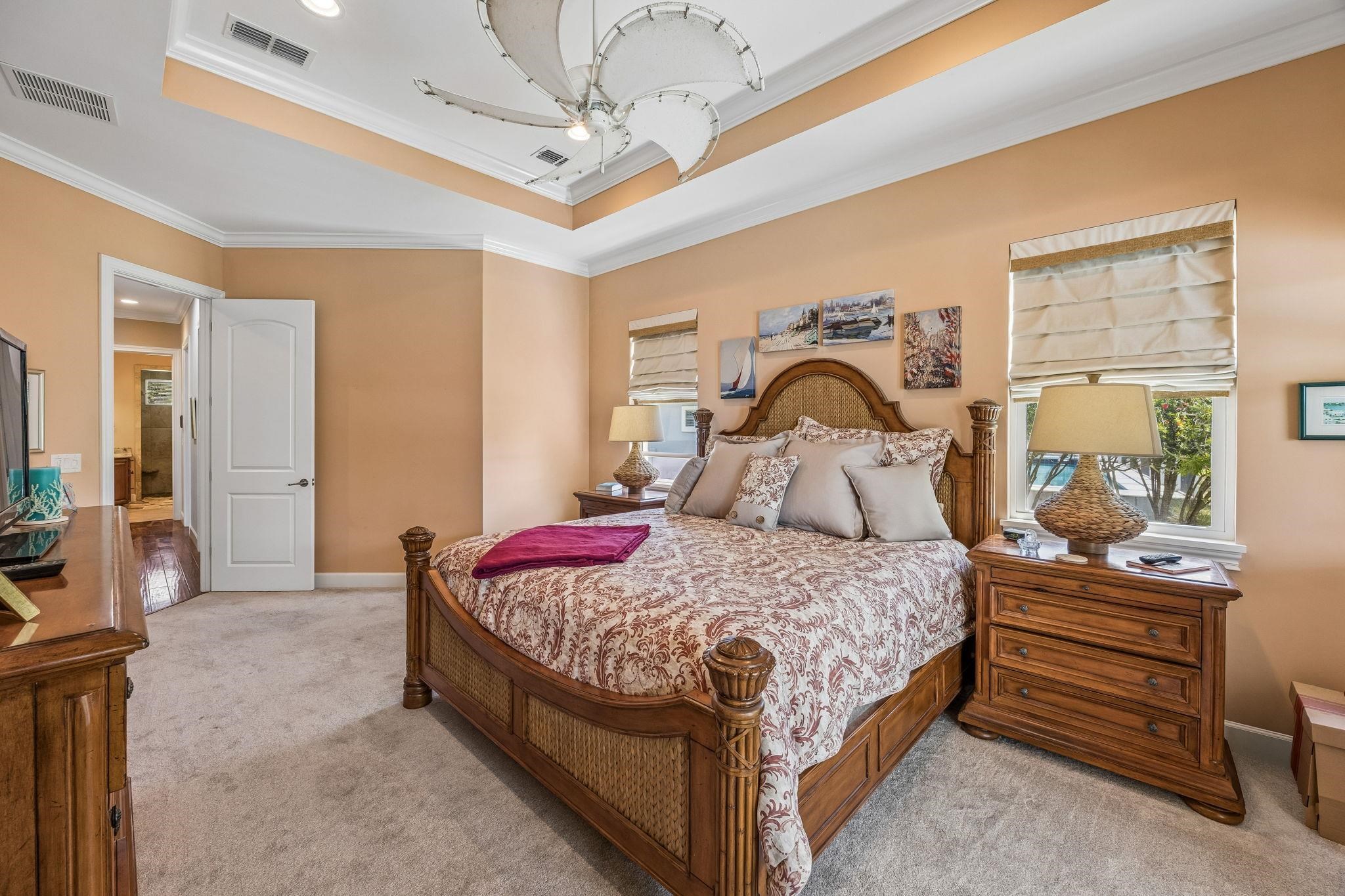 409 Lookout Point Drive St. Augustine, FL 32080 - Photo 47 of 90 Bedroom with ornamental molding, light colored carpet, and a raised ceiling