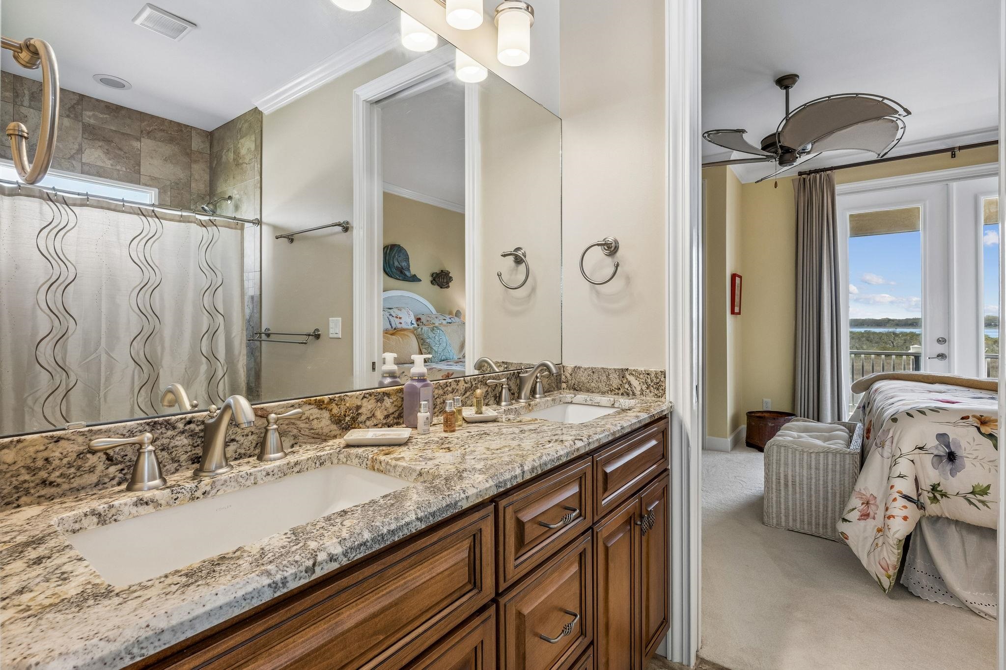 409 Lookout Point Drive St. Augustine, FL 32080 - Photo 55 of 90 Bathroom with ensuite bath, crown molding, double vanity, tiled shower, and light carpet