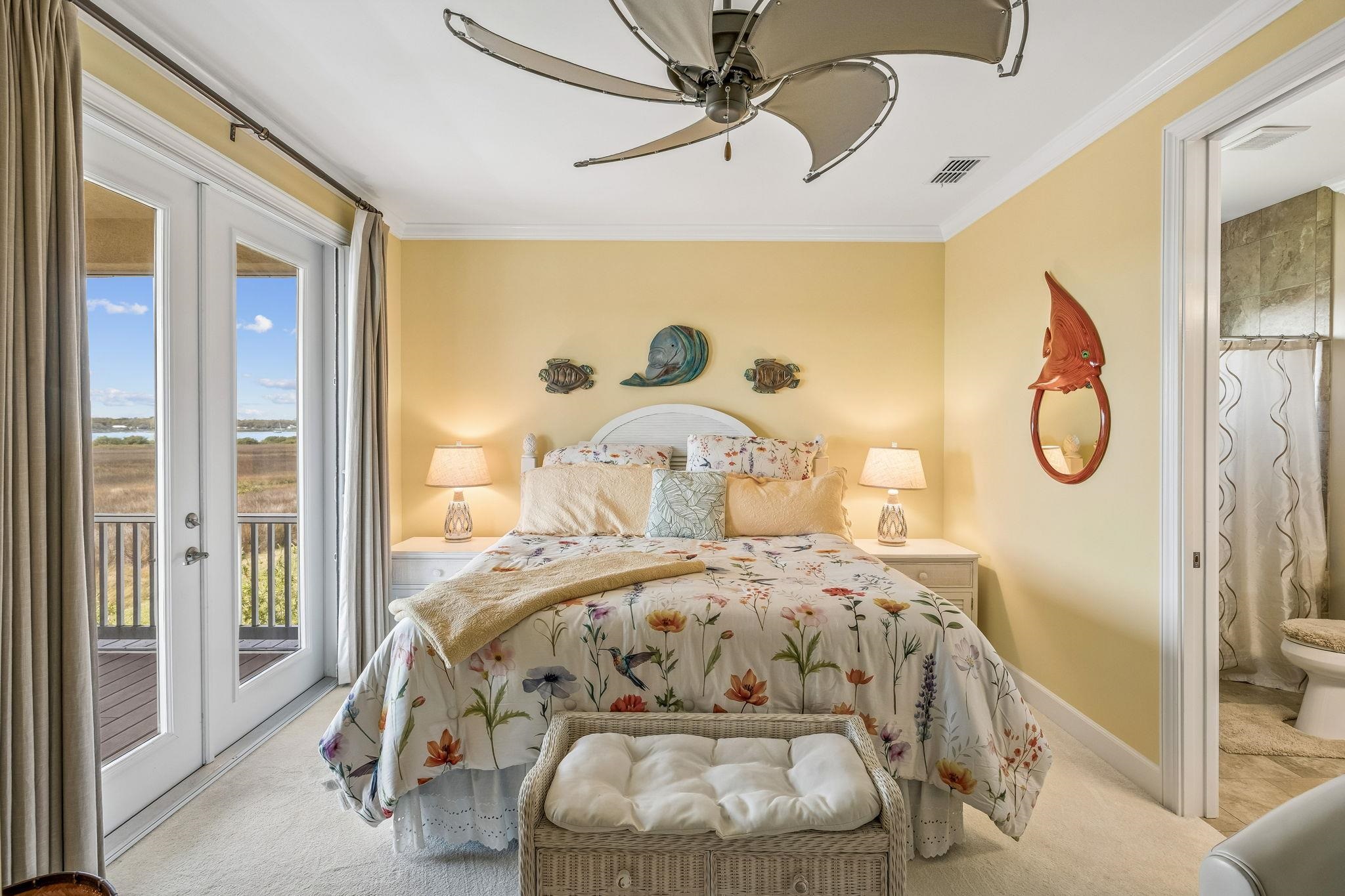 409 Lookout Point Drive St. Augustine, FL 32080 - Photo 62 of 90 a bedroom with a bed mirror and clock on the wall