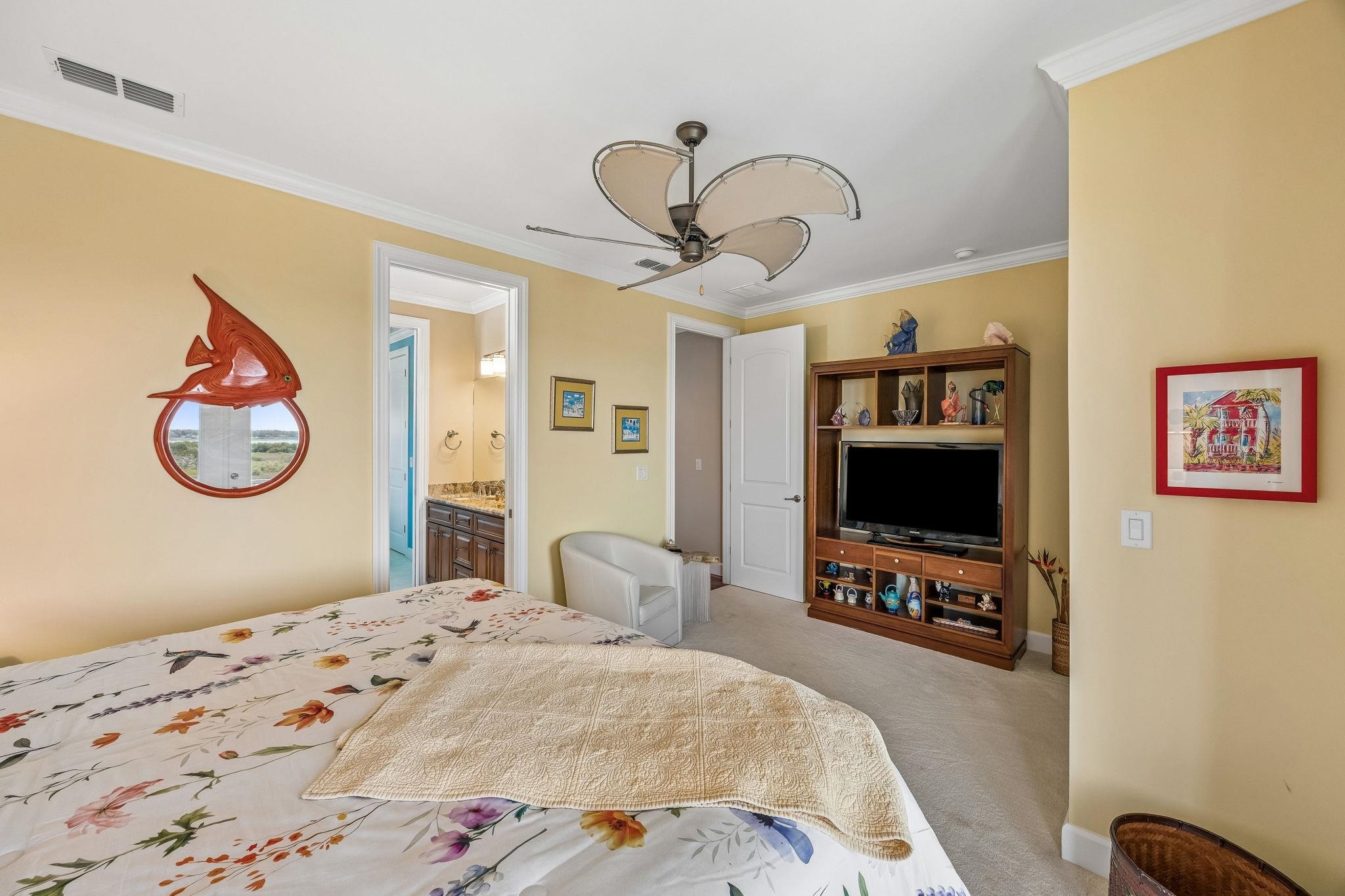 409 Lookout Point Drive St. Augustine, FL 32080 - Photo 64 of 90 Bedroom with light colored carpet, a ceiling fan, ornamental molding, and ensuite bath