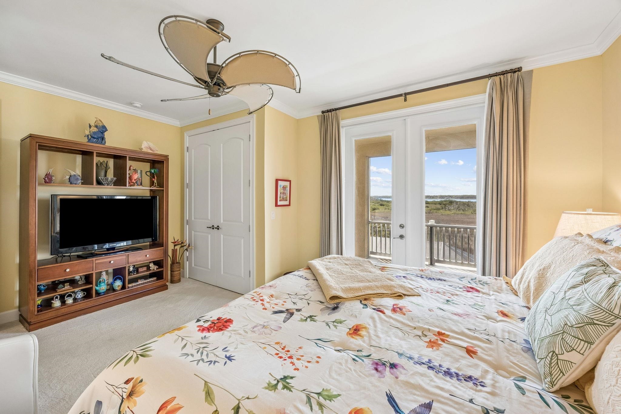 409 Lookout Point Drive St. Augustine, FL 32080 - Photo 65 of 90 a bedroom with a bed and a flat screen tv