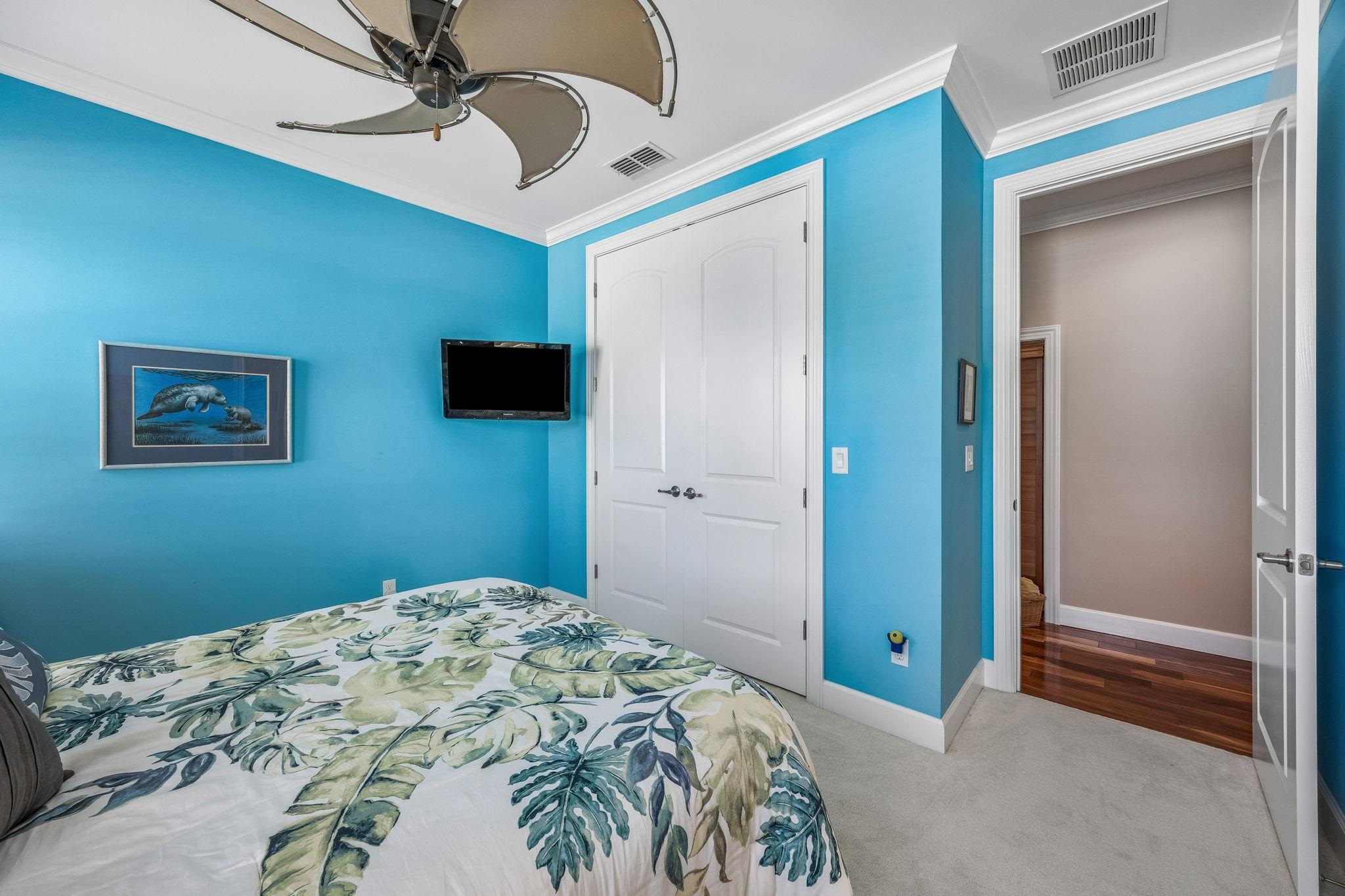 409 Lookout Point Drive St. Augustine, FL 32080 - Photo 69 of 90 a bedroom with a bed and a chandelier