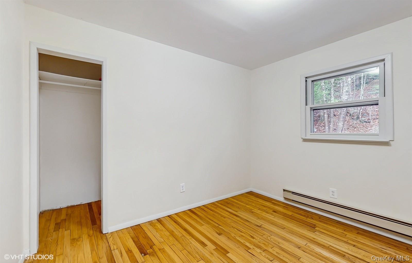 736 State Rte 55 Napanoch, NY 12458 - Photo 14 of 49 Unfurnished bedroom featuring a closet, light wood-style floors