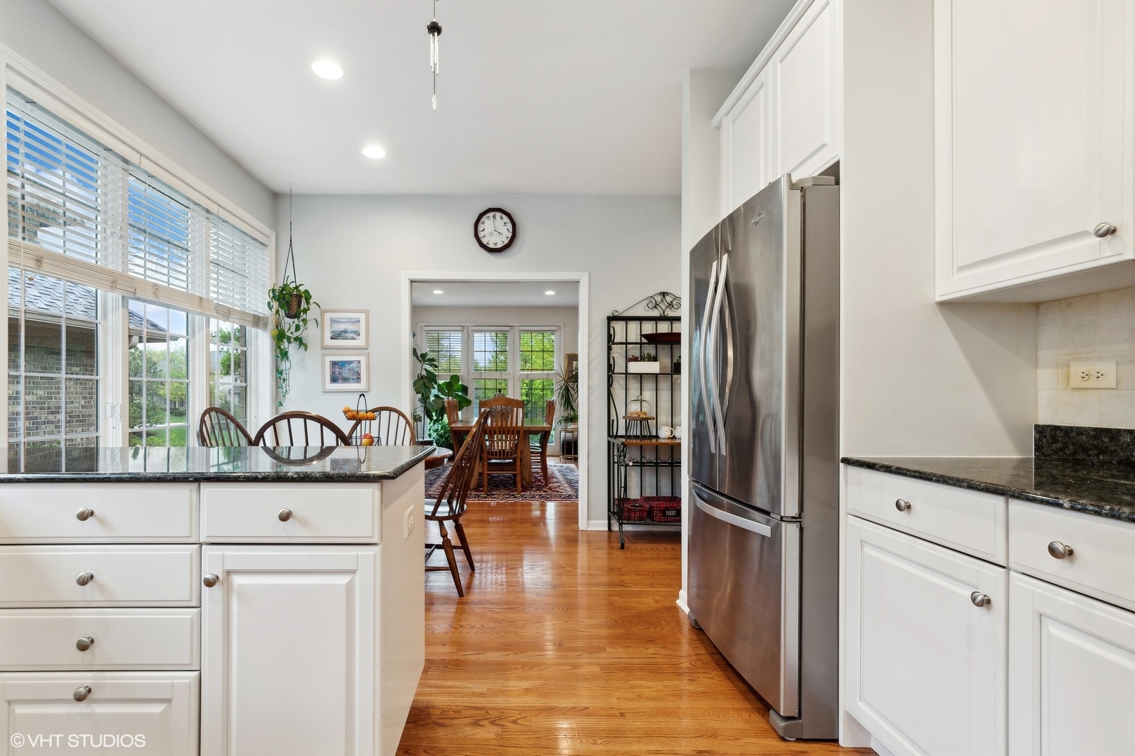 2013 Royal Ridge Drive Northbrook, IL 60062 - Photo 13 of 43 a kitchen with granite countertop a refrigerator a stove and white cabinets with wooden floor
