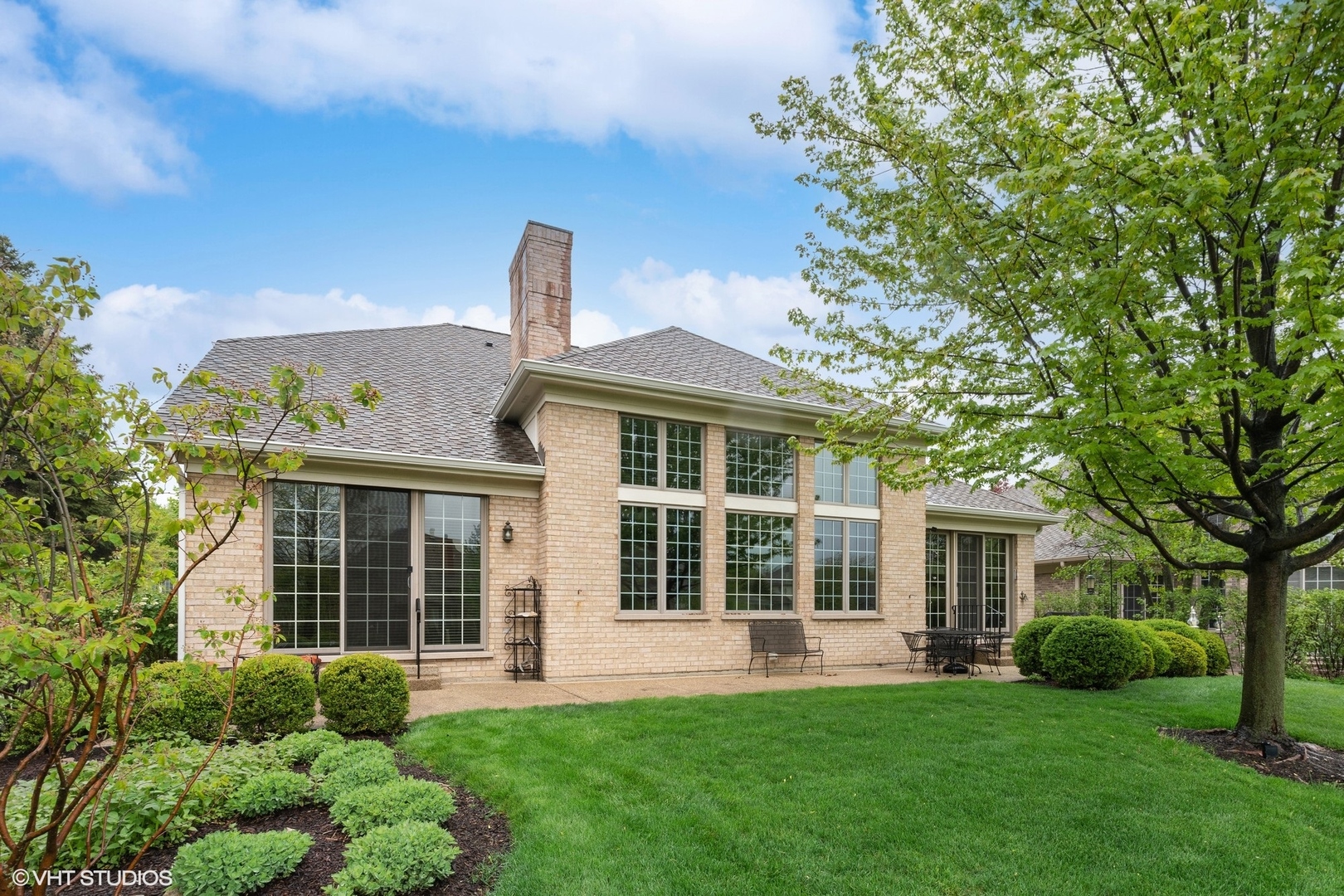 2013 Royal Ridge Drive Northbrook, IL 60062 - Photo 2 of 43 a front view of a house with a garden and yard