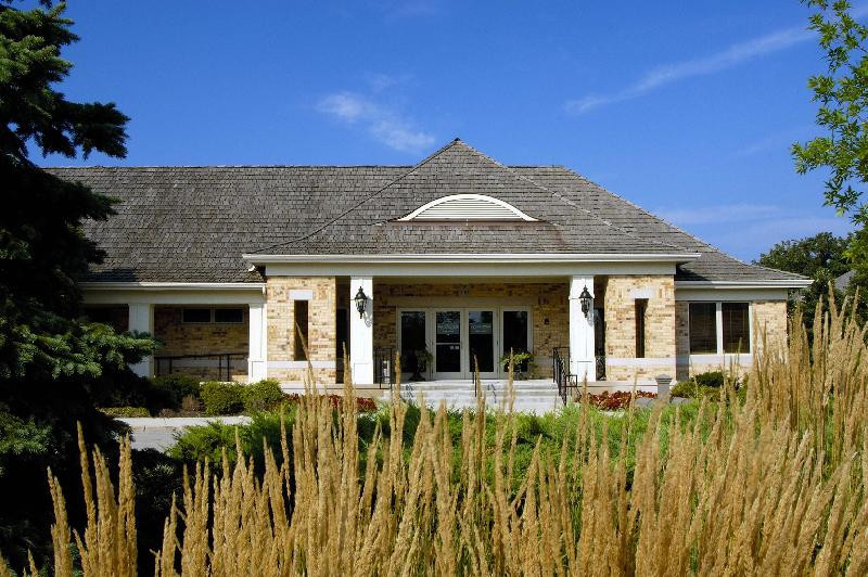 2013 Royal Ridge Drive Northbrook, IL 60062 - Photo 31 of 43 a view of a white house with large windows and a small yard