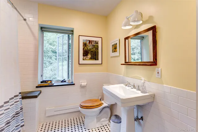 a bathroom with a toilet sink and mirror