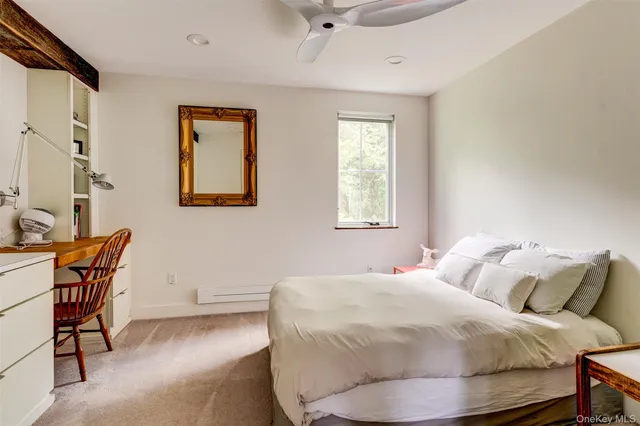 a bedroom with a bed chair and window