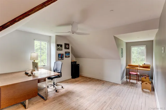a workspace with furniture hardwood and a window