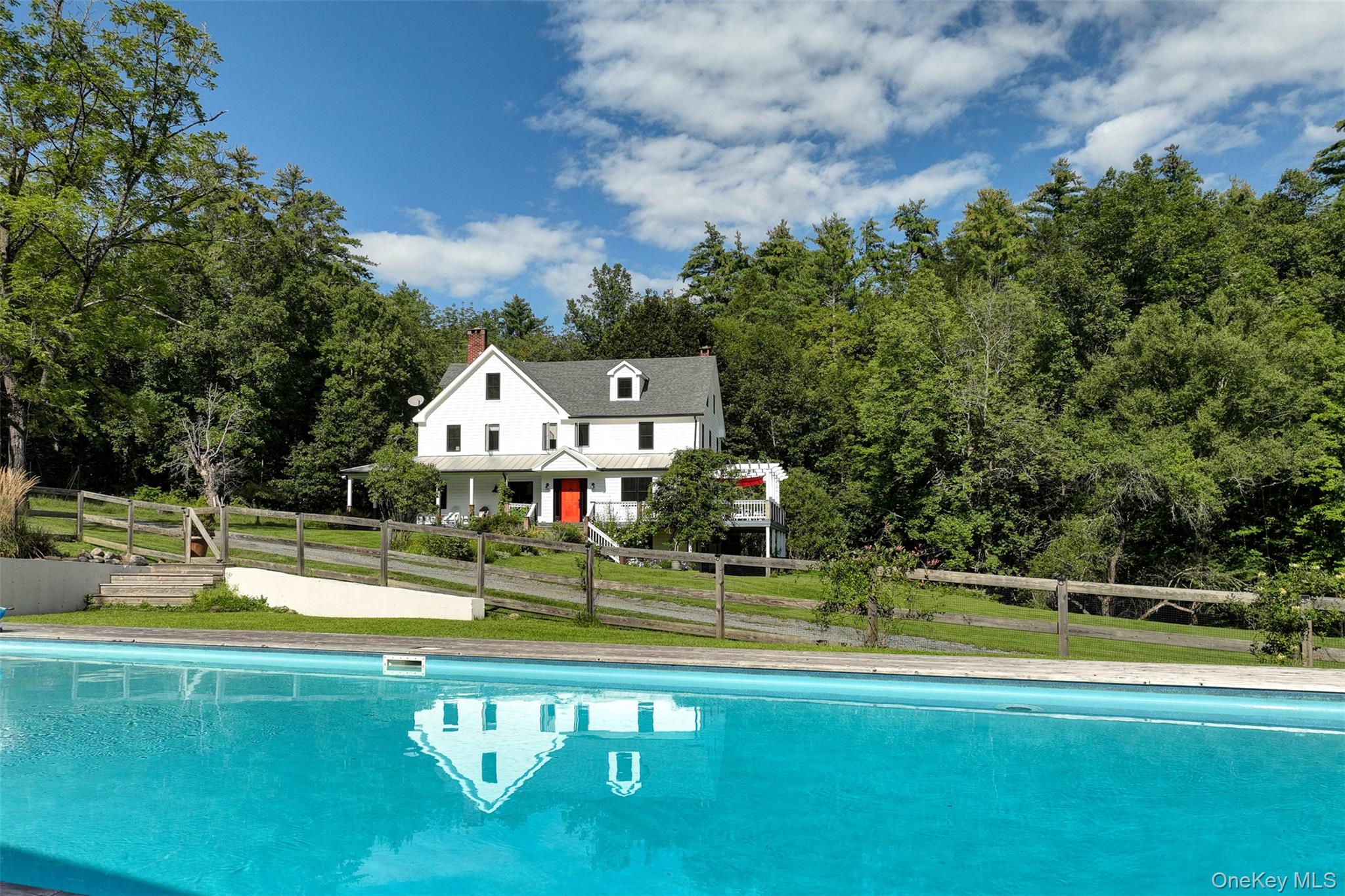 39 Deep Hollow Hill Road Narrowsburg, NY 12764 - Photo 45 of 47 a view of a swimming pool with a house in the background