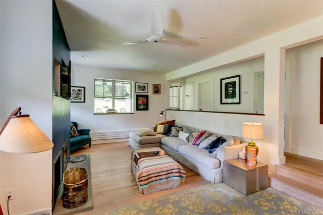 a living room with furniture a rug and a window