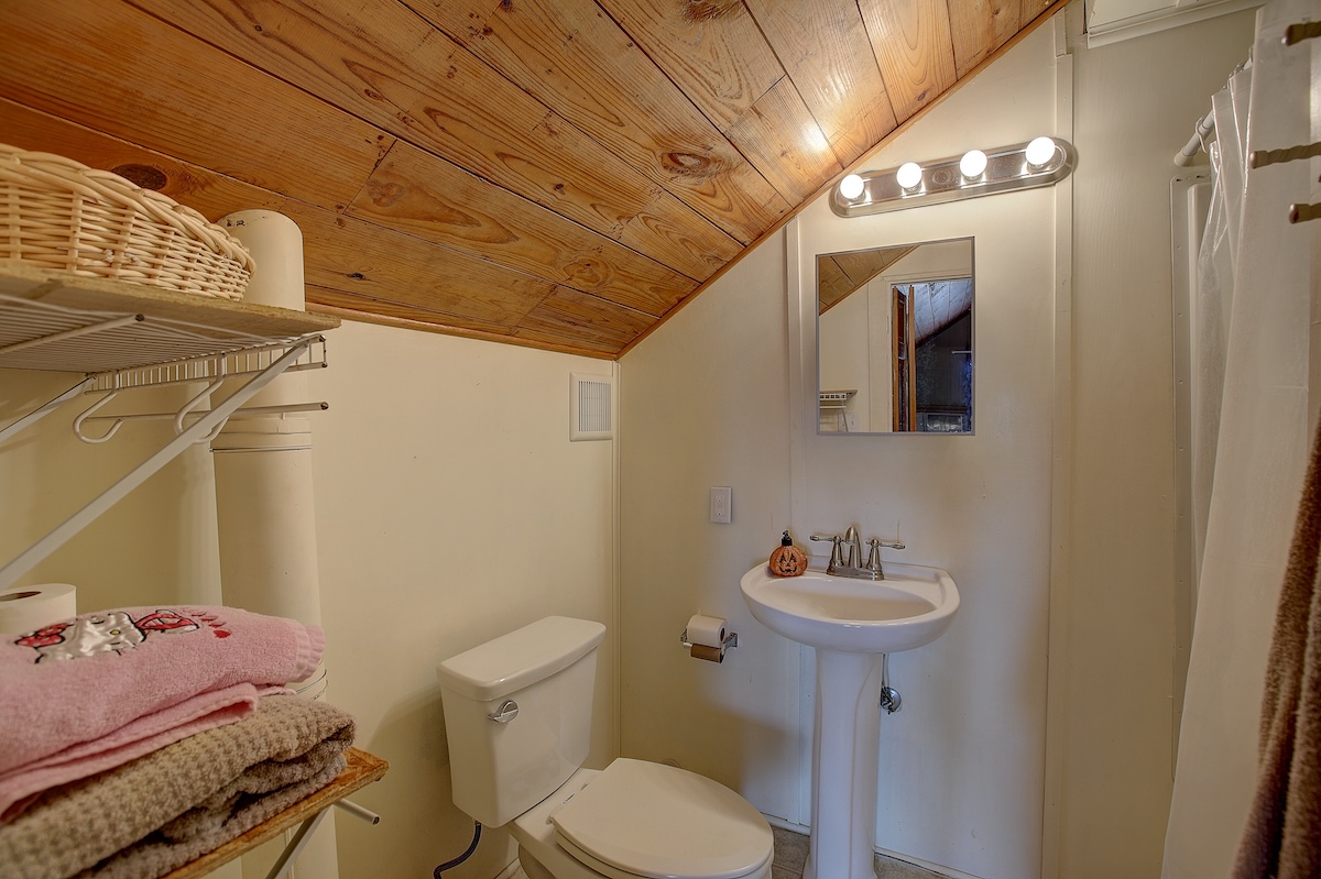 1708 Olive Street Georgetown, TX 78626 - Photo 25 of 38 Upstairs bathroom. Attic room and bath are cooled/heated by a wall unit. Carpeted but a lot of space