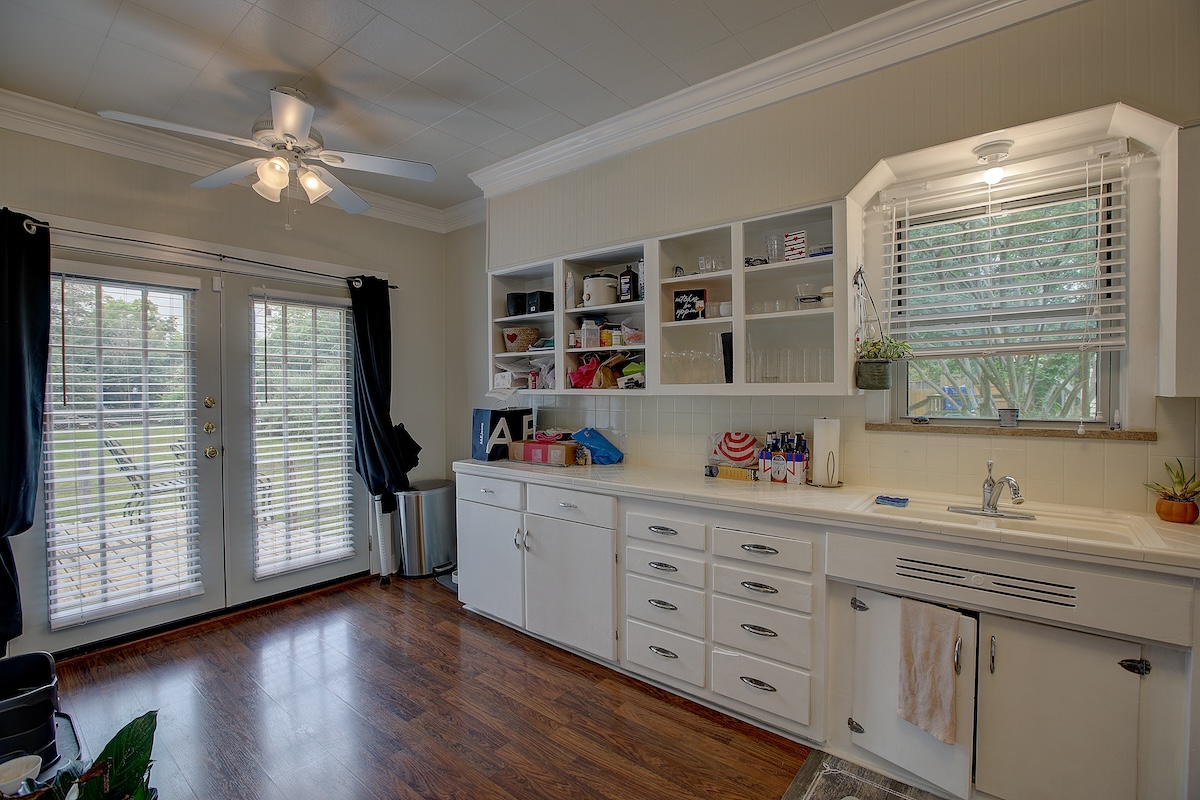 1708 Olive Street Georgetown, TX 78626 - Photo 26 of 38 The kitchen features open upper cabinets with room for breakfast table, French doors to back deck, ceiling fan.