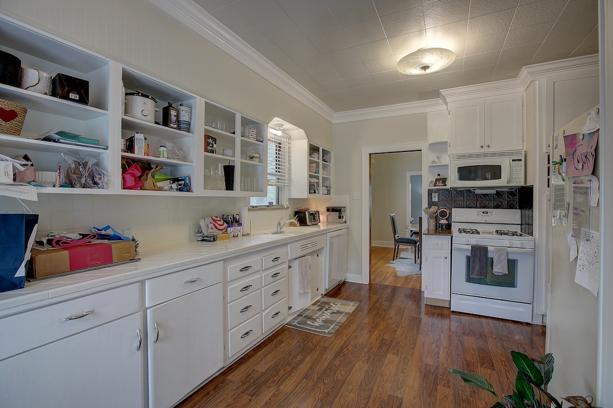 1708 Olive Street Georgetown, TX 78626 - Photo 5 of 38 Kitchen is large and open. Plenty of cabinets. Gas cooking, recent dishwasher. Washer/dryer/fridge in house and guest quarters convey.