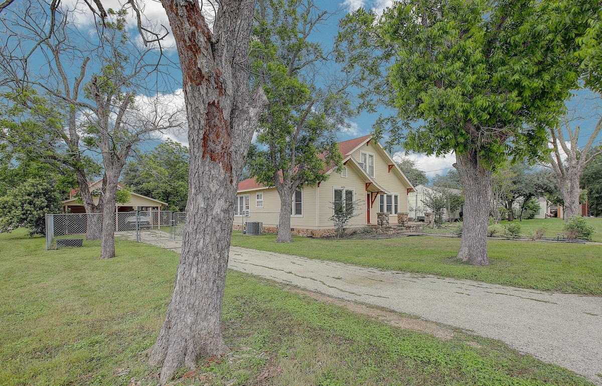 1708 Olive Street Georgetown, TX 78626 - Photo 9 of 38 Entry to the house portion of the yard. Gated for privacy. Carport serves the occupant of the house. Features a storage room or workshop area.