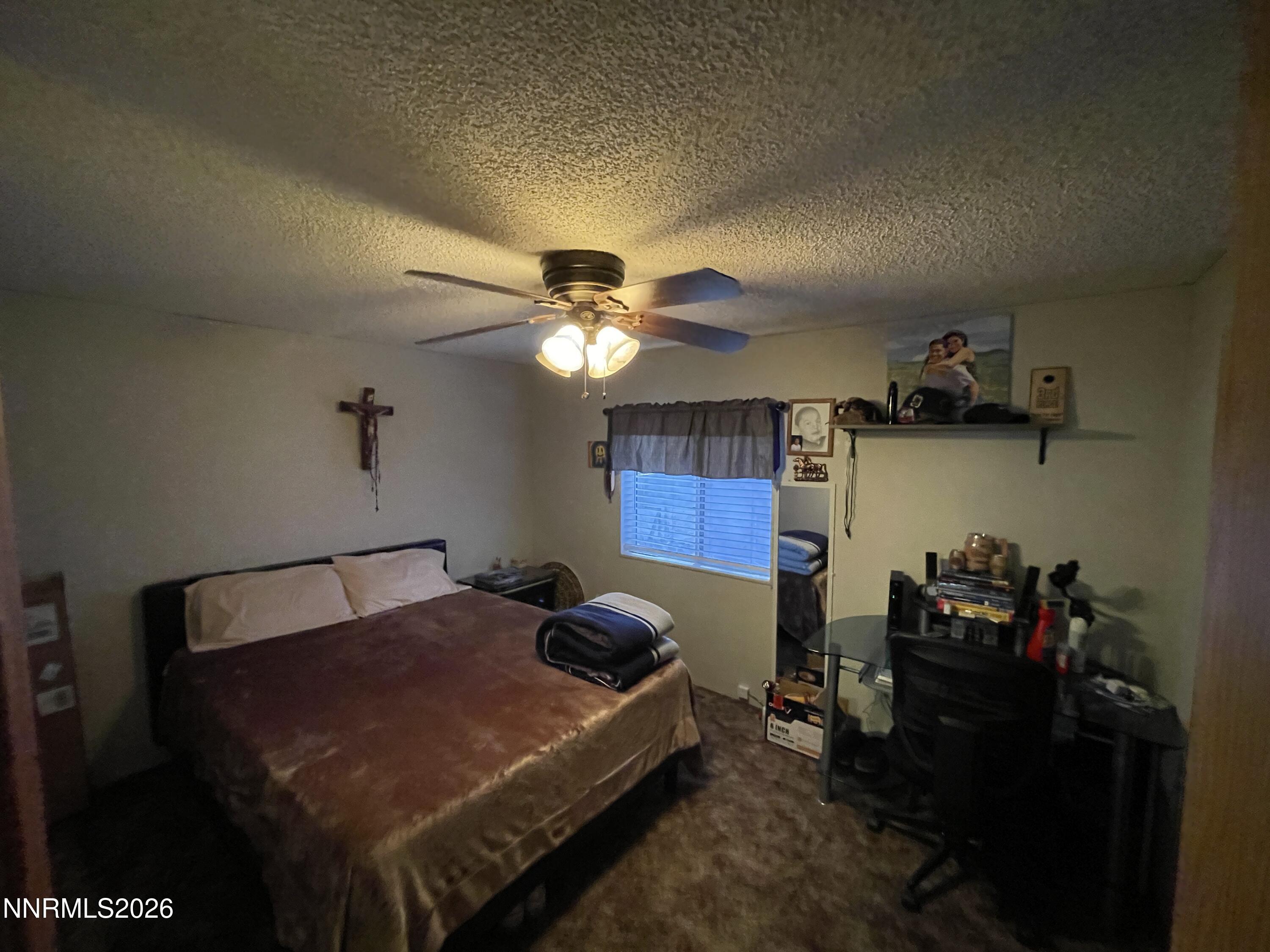 795 16th Street Lovelock, NV 89419 - Photo 16 of 28 a bedroom with a bed and a chandelier
