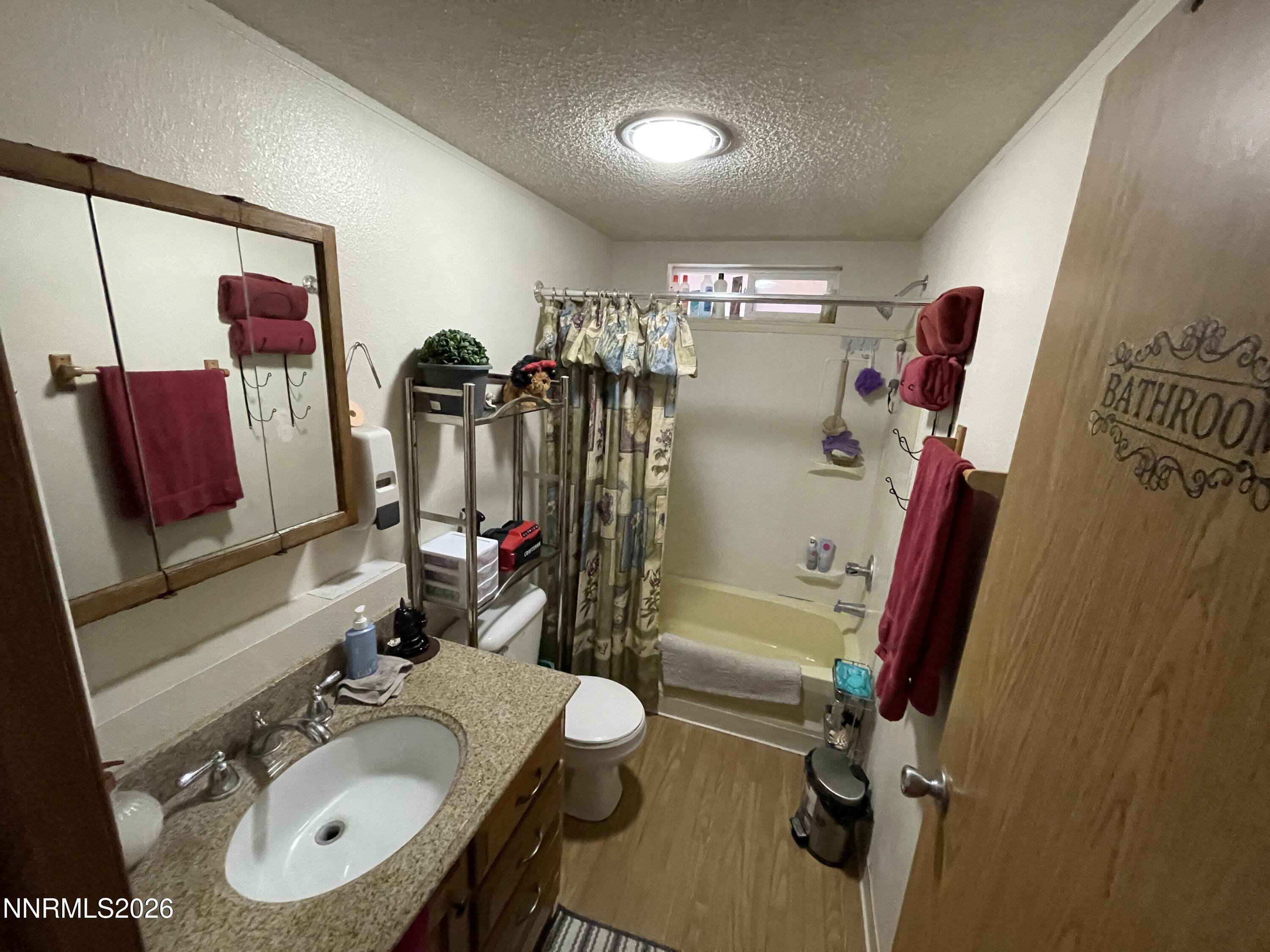 795 16th Street Lovelock, NV 89419 - Photo 17 of 28 a bathroom with a sink mirror vanity and toilet