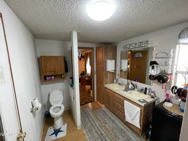 a bathroom with a sink mirror and toilet