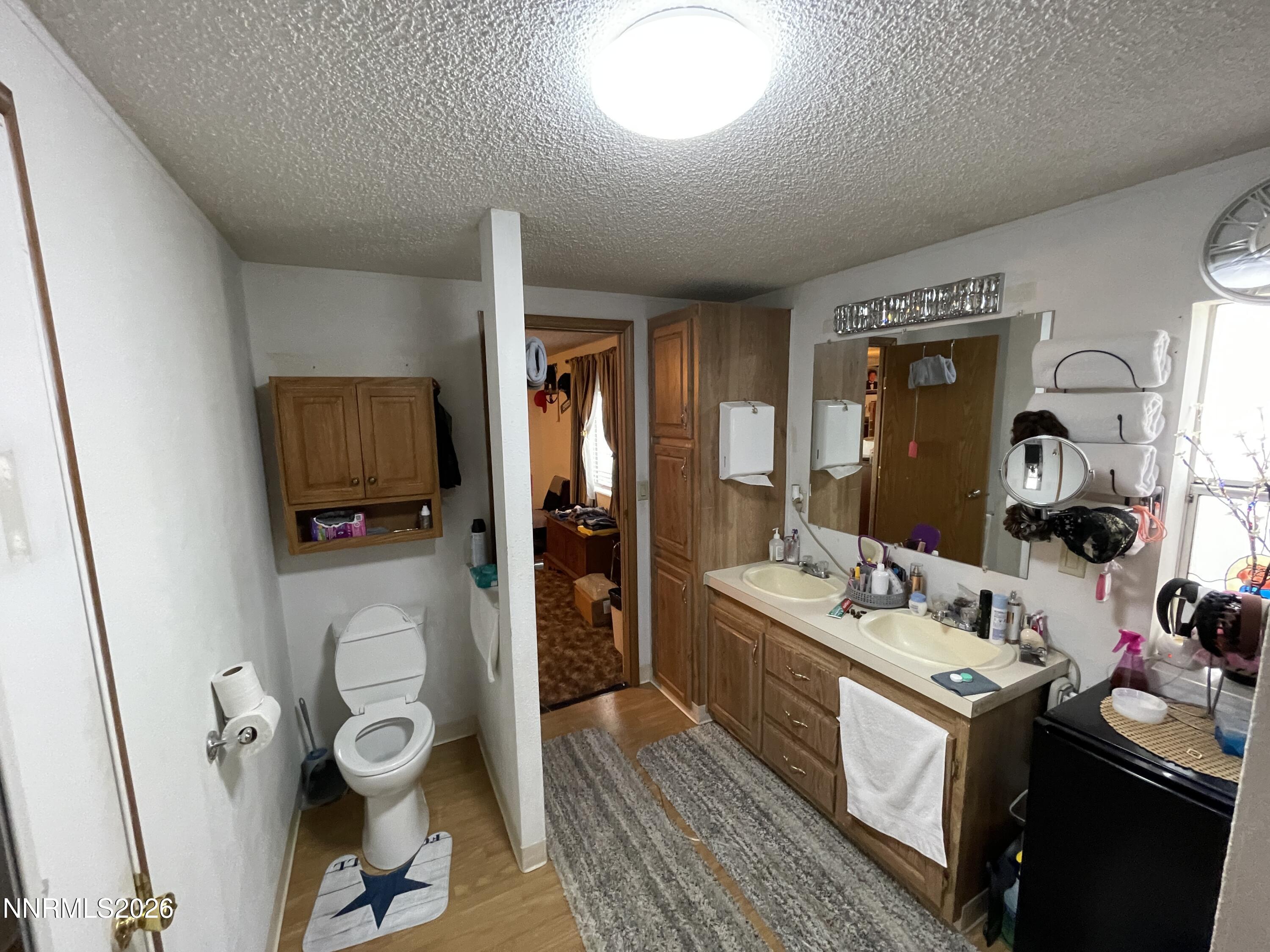 795 16th Street Lovelock, NV 89419 - Photo 23 of 28 a bathroom with a sink mirror and toilet