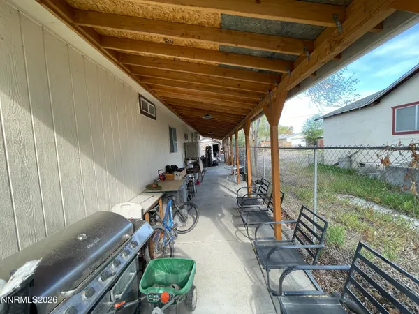 a view of a porch with furniture and garden